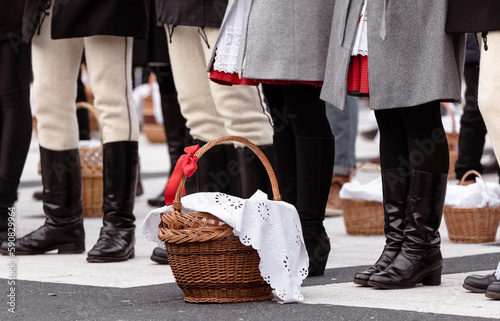 people with easter baskets in traditional sekler hungarian red black dress photo