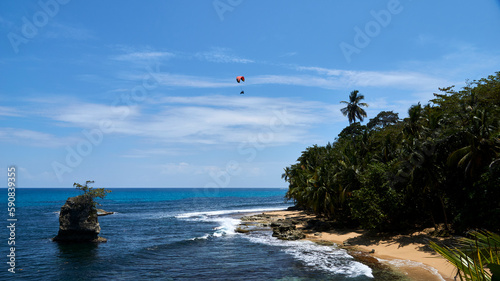 kitesurfer above a beach in caribbean costa rica