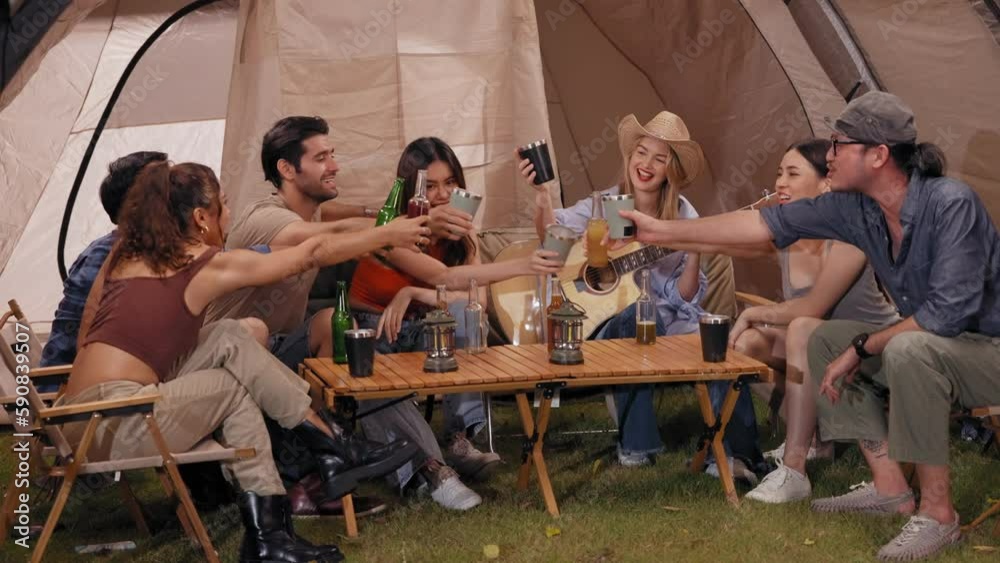 Happy young friends traveler group having fun music together in camping party, Group of multiculturalism hipster people enjoying holiday vacation trip in campsite Happy young friends traveler group having fun music together in camping party, Group of multiculturalism hipster people enjoying holiday vacation trip in campsite