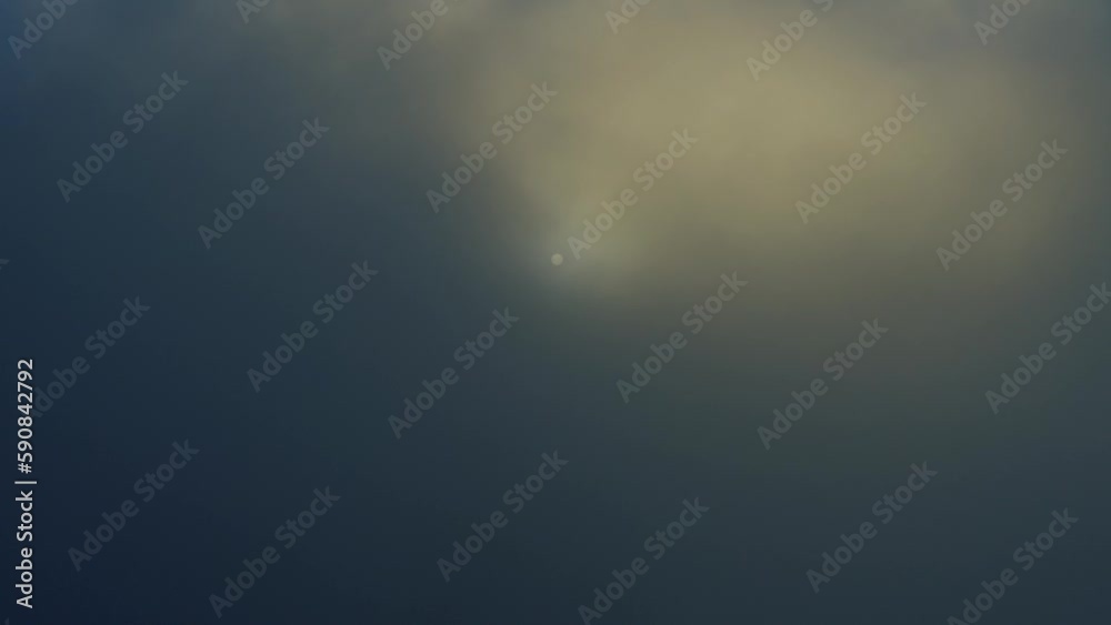 Sun disappearing into cloud layer - aerial