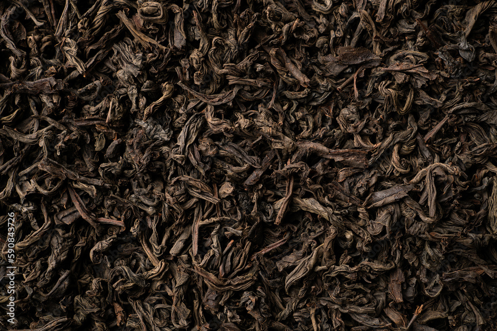 Background of black loose-leaf tea. Close up, top view Background of black loose-leaf tea. Close up, top view