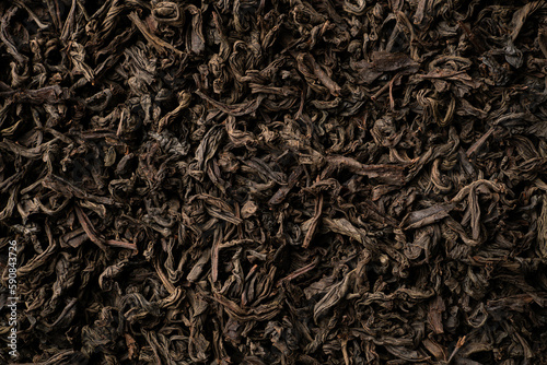 Background of black loose-leaf tea. Close up, top view