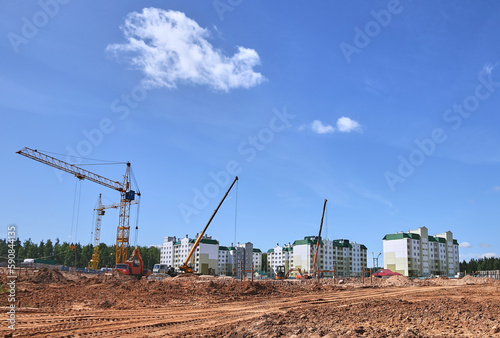 Panoramic view of construction sites and many cranes working