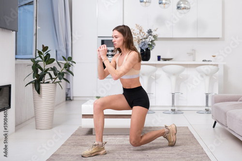 Fitness woman doing lunges exercises at home