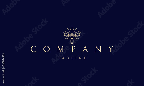 Vector golden logo on which an abstract image of a radiant phoenix with spread wings.