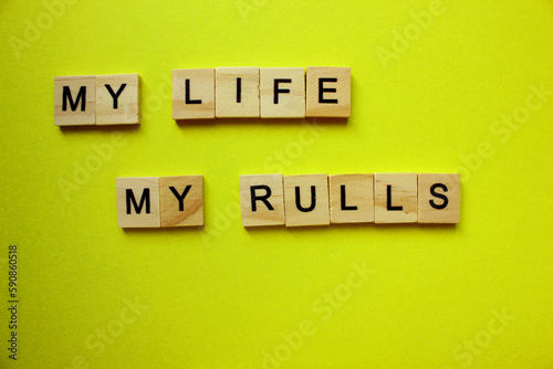 Tela my life my rules. lettering on the grass of paper-cut words.