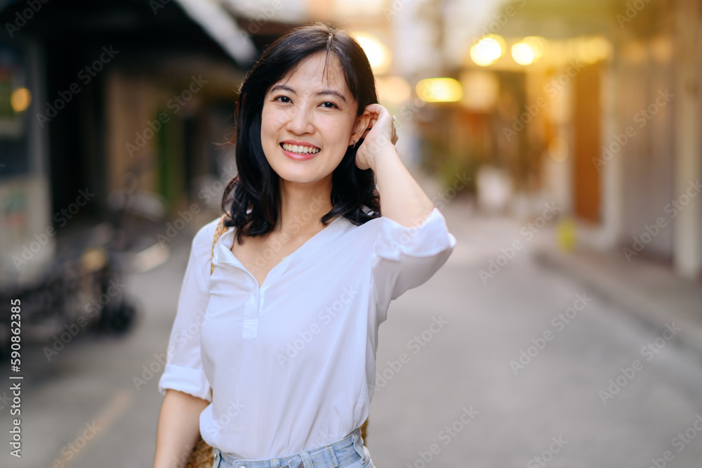 Portrait beautiful asian woman traveler smiling while explore street on summer vacation in Bangkok, Thailand