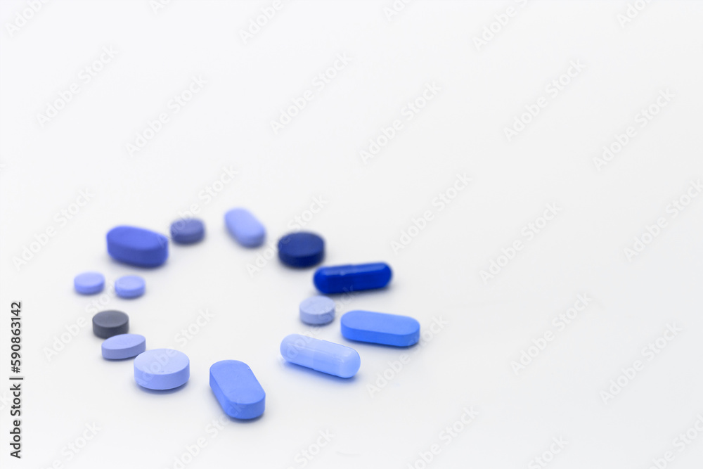 Assorted pills on a neutral background with light blue colors. Concept of pills used for male erection.