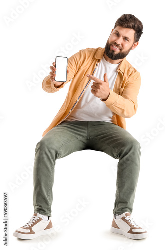 Young bearded man pointing ...