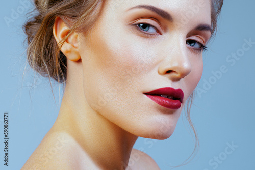 Beautiful blonde with perfect skin and burgundy lips in close-up. Skin care and makeup
