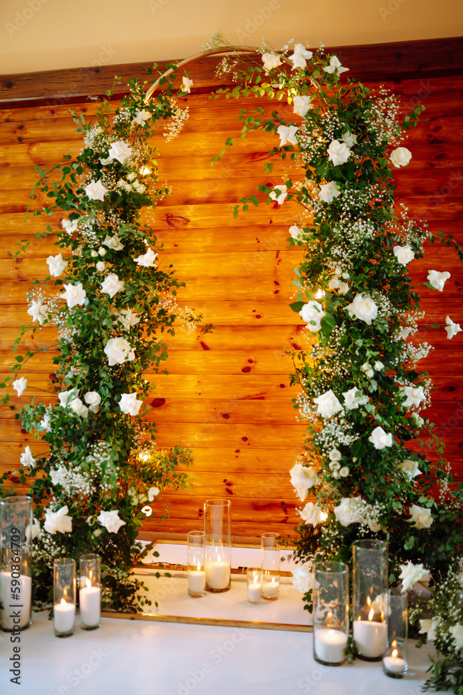 Wedding ceremony. Wedding arch decorated with white flowers. A very