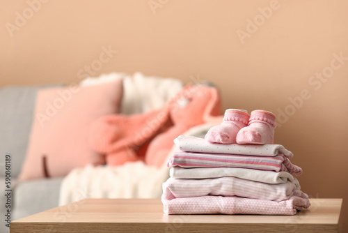 Canvastavla Stack of baby clothes and socks on table in room
