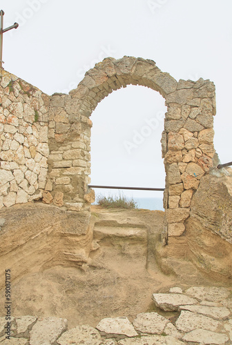 The walls of an ancient fortress on the edge of the rocks on the Black Sea coast. Medieval fortress 