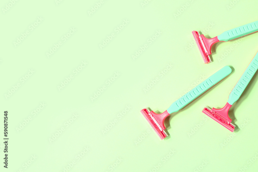 Set of safety razors on green background Set of safety razors on green background