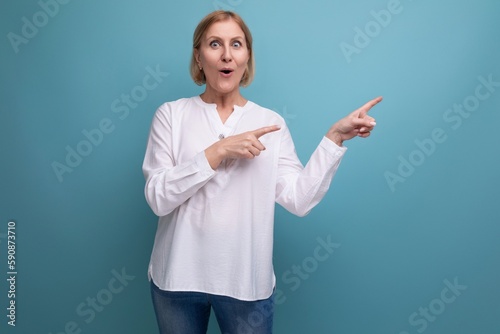 surprised shocked middle aged blonde bob woman in white blouse on studio background
