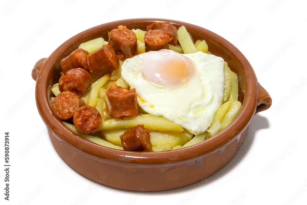 Chistorra with fried potatoes and fried eggs, served in a clay bowl (Chistorra, is a type of sausage of Navarre origin made with fresh minced pork.Isolated in a white background. Spanish food concept. Chistorra with fried potatoes and fried eggs, served in a clay bowl (Chistorra, is a type of sausage of Navarre origin made with fresh minced pork.Isolated in a white background. Spanish food concept.