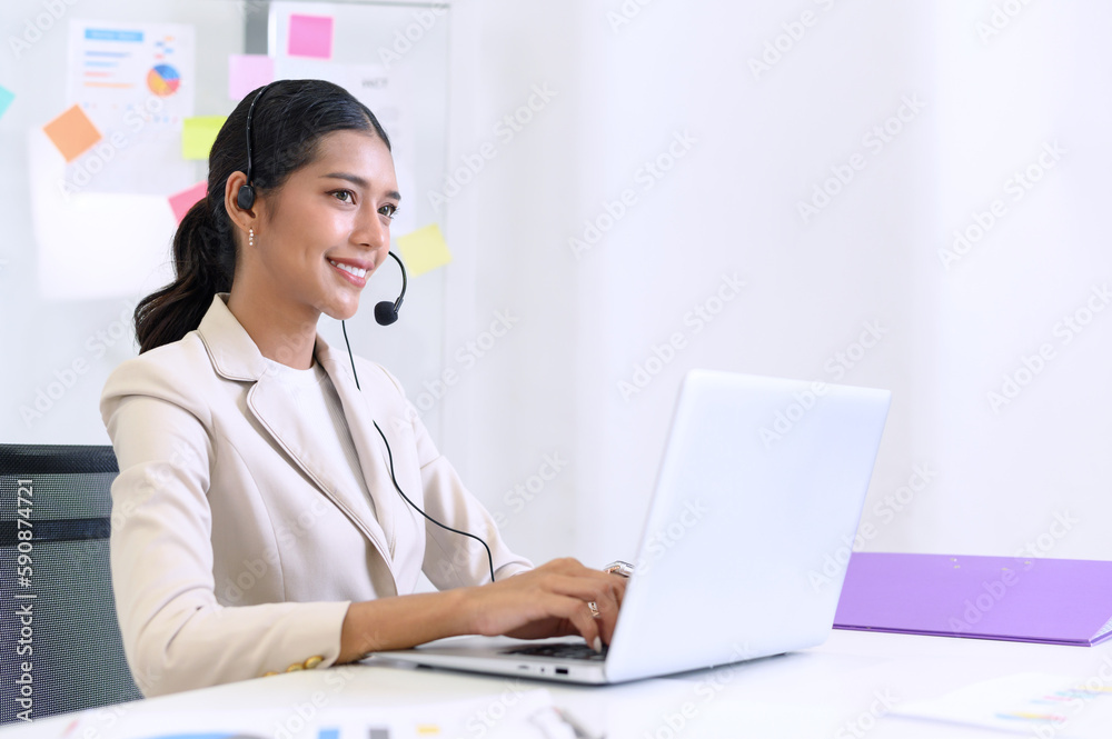 Young beautiful friendly operator woman with headset working in a call center. customer service pay attention and talking to customers while using computer at office. Young beautiful friendly operator woman with headset working in a call center. customer service pay attention and talking to customers while using computer at office.