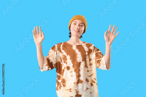 Teenage boy waving hands on...