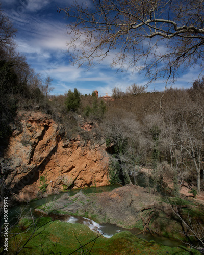 Mountainous landscape with river and cloudy sky photo