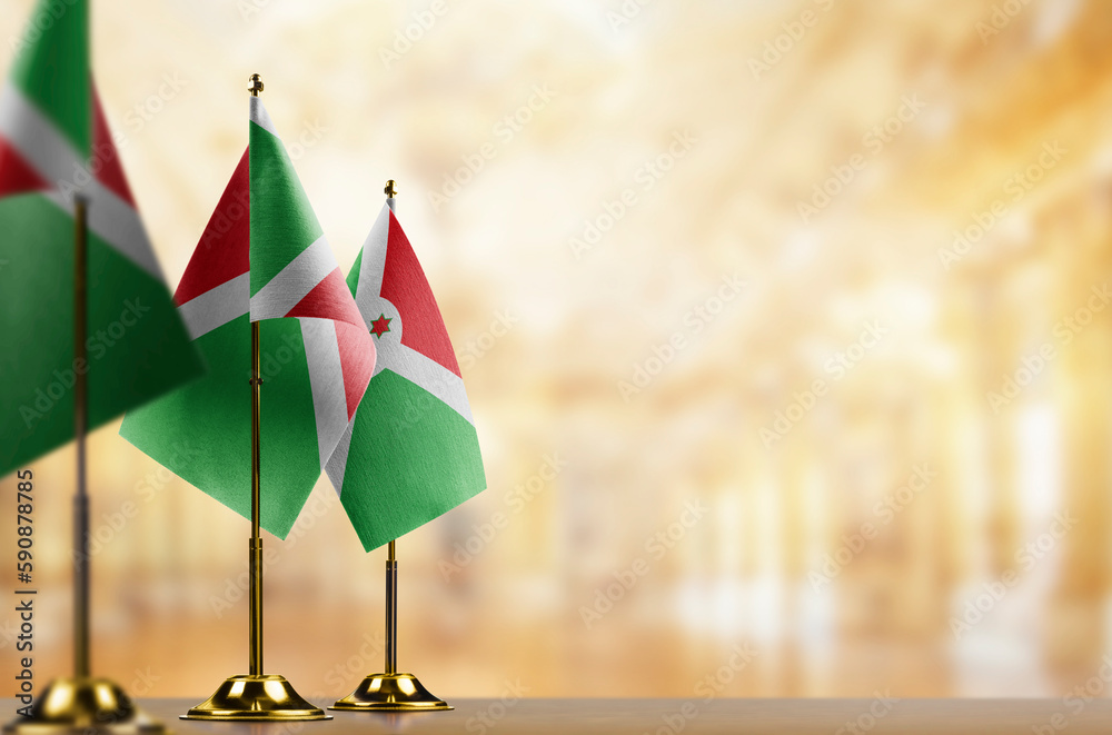 Fototapeta premium Small flags of the Burundi on an abstract blurry background