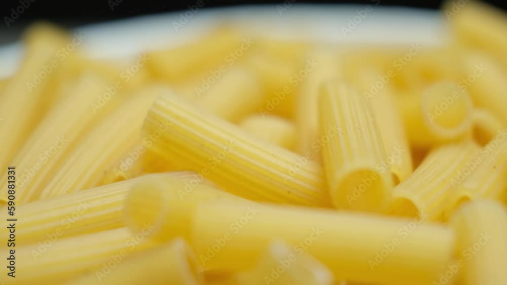 Wheat pasta Rigatoni in the form of tubes, close-up. Wheat pasta Rigatoni in the form of tubes, close-up.