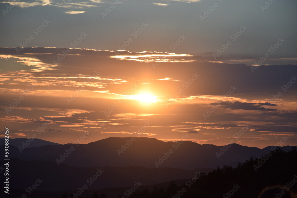 Fototapeta premium Madonna dei fornelli, Italy: Very colorful sunset over the Italian Apennines in a small village. atmosphere of peace and serenity.