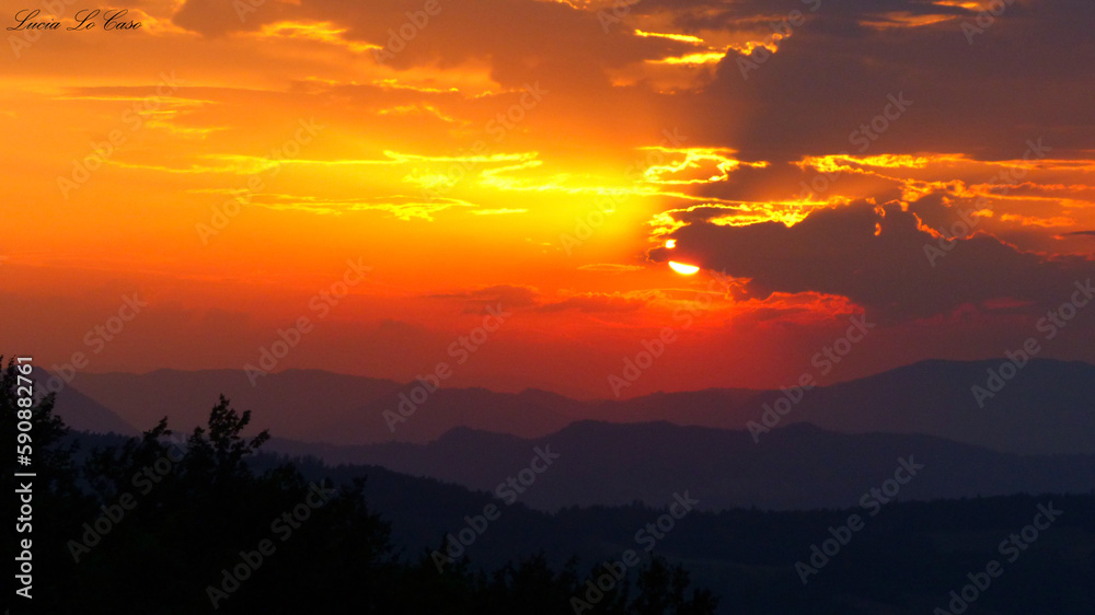 Fototapeta premium Madonna dei fornelli, Italy: Very colorful sunset over the Italian Apennines in a small village. atmosphere of peace and serenity.