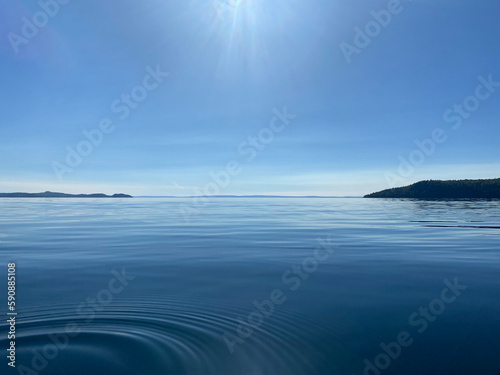 Beautiful Lake Superior in Thunder Bay Ontario during the daytime with Blue water and mountains in the background