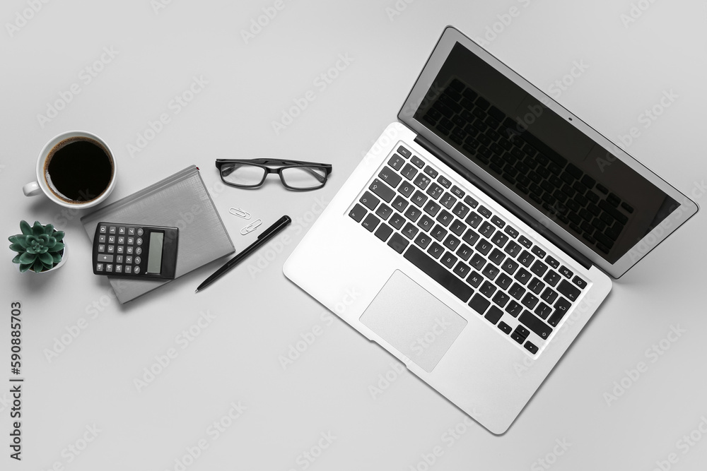 Composition with laptop, coffee and calculator on grey background Composition with laptop, coffee and calculator on grey background