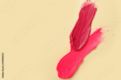Pink lipstick strokes on beige background