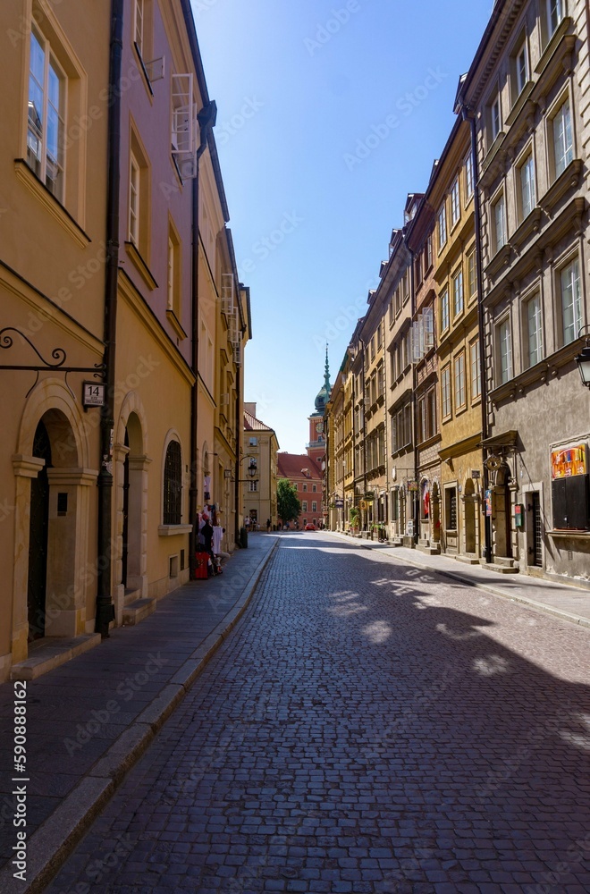 Street in the city center of Warsaw, with the palace in the background, on a sunny day.