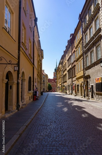 Street in the city center of Warsaw  with the palace in the background  on a sunny day.
