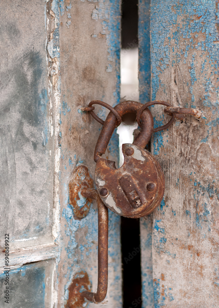 Old rusty lock on a wooden door Old rusty lock on a wooden door