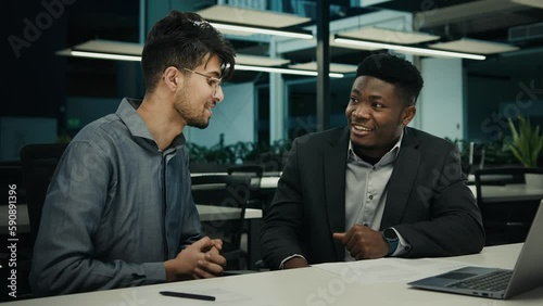 Wallpaper Mural Two diverse men with laptop discuss project African american broker advisor manager consulting Indian man client satisfied businessmen shake hands partnership in office handshake at business meeting Torontodigital.ca