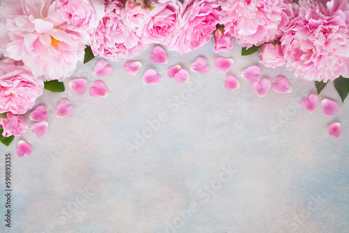 Pink peonies and roses on a colorful decorative background, space for text congratulations, invitations to a holiday, wedding