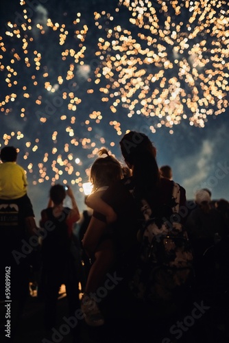 mom and daughter watching fireworks