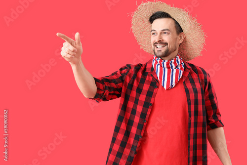 Handsome man pointing at so...
