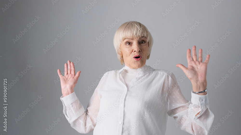 Surprised elderly woman with wide-open eyes on a white background. Surprised elderly woman with wide-open eyes on a white background.
