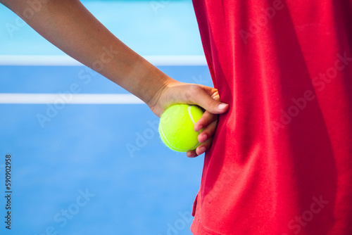 Close-up of a tennis player's hand holding a tennis ball and racket © Павел Мещеряков