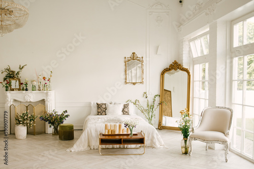 Large white bedroom with large windows, beautiful bright interior