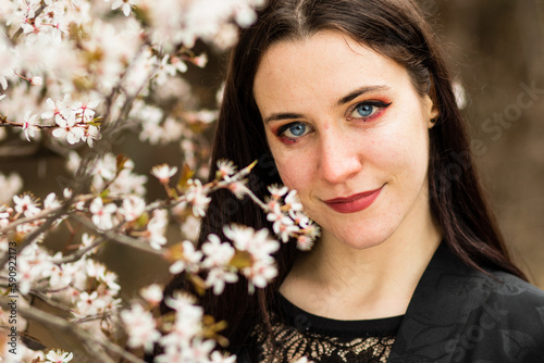 unaltered imagery skincare dermatology beauty. Hispanic woman portrait with cherry blossom photo