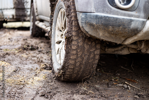 off-road vehicle with muddy wheels. Driving off-road and in bad weather