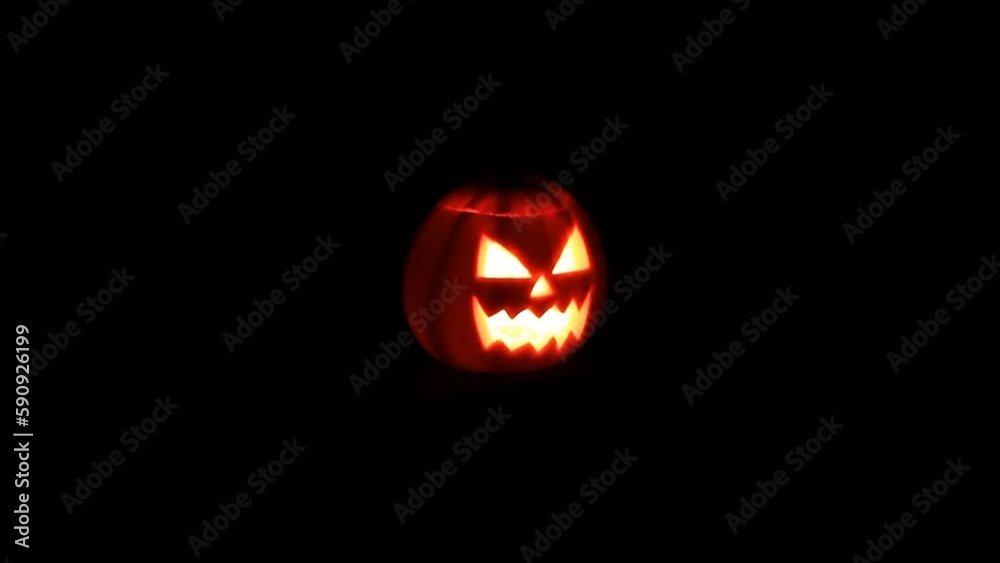 Scary Halloween pumpkin face with glowing candle in the Dark. Scary Halloween pumpkin face with glowing candle in the Dark.