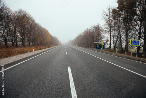 Empty long mountain road to the horizon on a sunny summer day at bright sunset - speed motion blur effect