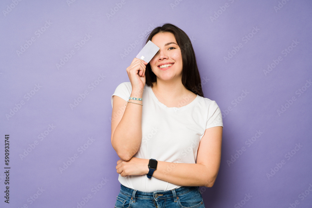 Beautiful cheerful woman using her credit card Beautiful cheerful woman using her credit card