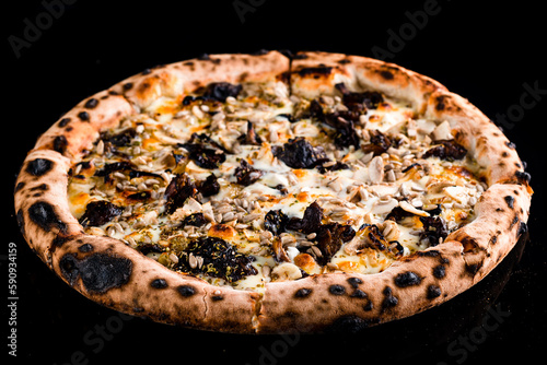 Italian lunch pizza with mushrooms, onions, cheese, sunflower seeds and spices isolated on black.