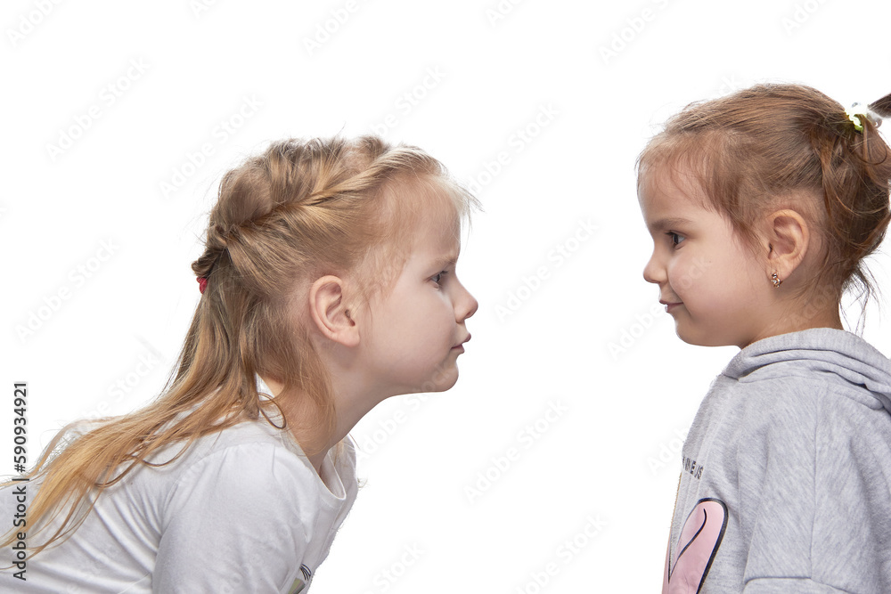 Children look at each other, pierced ears and without piercing. the concept of choice. Children look at each other, pierced ears and without piercing. the concept of choice.