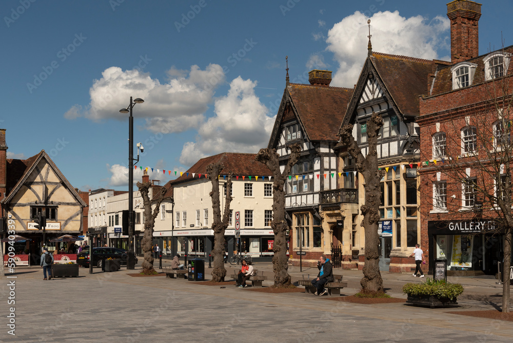 Salisbury, Wiltshire, England, UK. 2023. People walk on Market Place in the city centre surrounded with historic buildings, shops and offices.