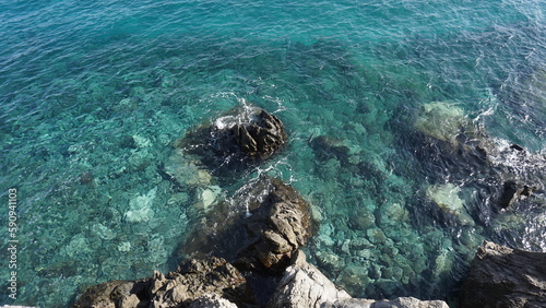 Crystal clear ocen water with volcanic rocks visible on the bottom in Tenerife, Canary Islands, Spain