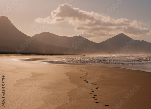 Scenic view on the beach Cofete, ocean water and footprints in the sand on Fuerteventura, Spain - Canary Islands